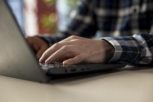 Worker at home office desk editing documents on notebook, updating reports and files, typing text. Close up of employee managing digital documents within file directories on laptop photo