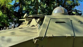 Explore the intricate and detailed design of an armored military vehicle as it is surrounded by lush greenery photo