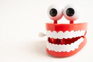 Funny red teeth with eye toy denture model for dental health care. photo