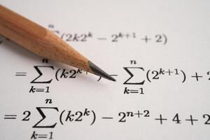 Pencil on mathematic formula exercise test paper in education school. photo