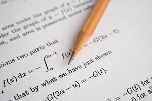 Pencil on mathematic formula exercise test paper photo