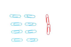 A Group of Blue Paper Clips Isolated with Two Red Paper Clips Linked Together photo