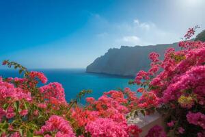 Vibrant Bougainvillea Flowers Framing a Scenic Coastal View with Turquoise Sea and Mountain Scenery photo