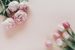 Elegant floral composition with pink peonies and tulips on a light background providing ample copy space for spring themed designs and invitations photo