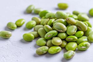 Fresh Shelled Edamame Beans on White Surface with Soft Shadows photo