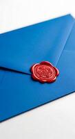 A close up of a blue envelope sealed with a red wax stamp on a white surface showing the details photo