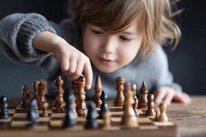 Young child playing chess on wooden board, focused and engaged in game photo