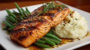 Enjoy a delicious keto dinner featuring grilled salmon alongside creamy cauliflower mash and crisp green beans. A perfect meal for health-conscious diners looking to indulge. photo