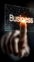 close-up image of a human finger touching a glowing business symbol photo