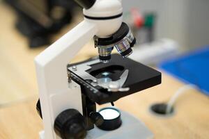professional microscope in a school laboratory for the study of cells and bacteria- photo