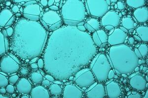 The texture of soap bubbles and foam in close-up on a green background. photo