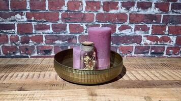 A gold bowl with a candle and a pink candle video