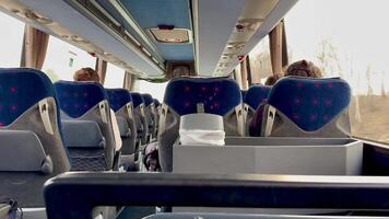 A view of the inside of a bus with people sitting video