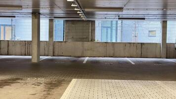 An empty parking garage with a car parked in it video