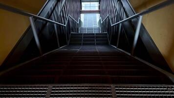 A stairway with metal railings and a window video