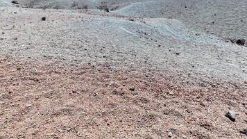 Embarking on an adventurous journey through the vast desert with rocky soil and unique patterns under sunlight video
