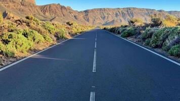 A scenic and serene road gracefully winding through the breathtaking mountains and vibrant, lush vegetation video