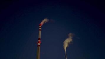 Two chimneys with smoke coming out of them video