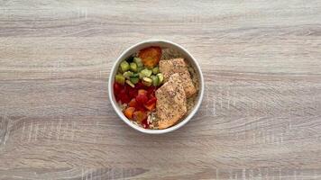 This nutritious salmon bowl, featuring a vibrant array of colorful veggies and rice, is perfect for healthy eating video
