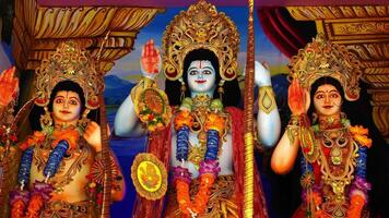 Three statues of hindu deities in a temple video