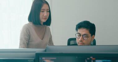 Group Adult Asia male, female freelance meeting write prompt AI bot IT app smart program nomad, game, talk strategy, discuss plan, user interface, designer, big data center on desktop computer. video