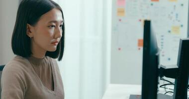 ung vuxen Asien kvinna frilans skriver skriva prompt ai bot den app smart program nomad, spel, terminal med kodning språk, användare gränssnitt, designer, stor data Centrum på skrivbordet dator video