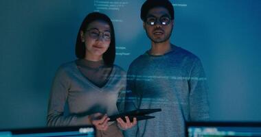 Group Asia male female software developers mentor leader manager talk strategy plan to executive write prompt AI bot IT app program nomad, game, data center. Projecting. video