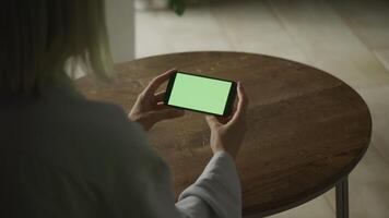 Woman Holding Smartphone with Green Screen Horizontally video