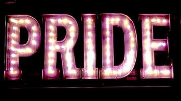 Illuminated Marquee Sign Spelling PRIDE in Vibrant Lights. photo