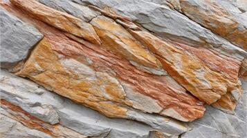 Natural stone texture with layered orange and gray rock surface showing rough and weathered patterns photo