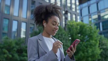 Young Businesswoman Walking and Browsing Smartphone video