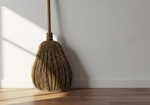 Broom against white wall photo