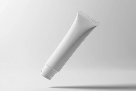 Minimalist white cosmetic tube floating against a soft gray gradient backdrop photo