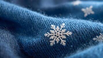 Blue knitted fabric adorned with delicate white snowflake patterns capturing the essence of winter holiday cheer and photo