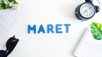 Flat lay composition with blue color foam letters spelling word MARET isolated on white background photo