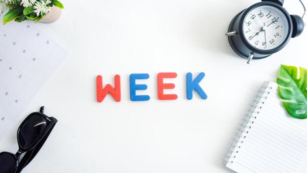 Flat lay composition with blue and red color foam letters spelling word WEEK isolated on white background photo
