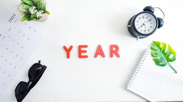 Flat lay composition with red color foam letters spelling word YEAR isolated on white background photo