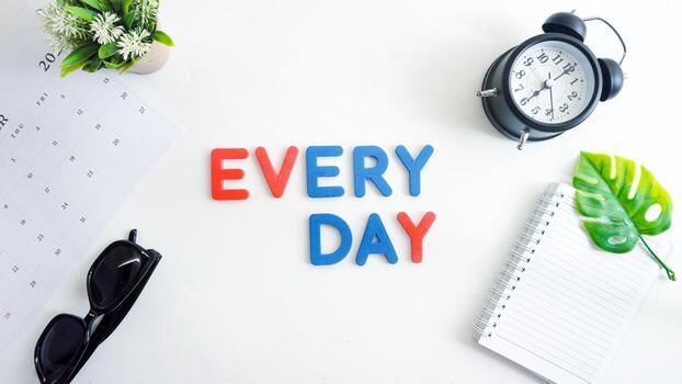 Flat lay composition with red and blue color foam letters spelling word EVERY DAY isolated on white background photo