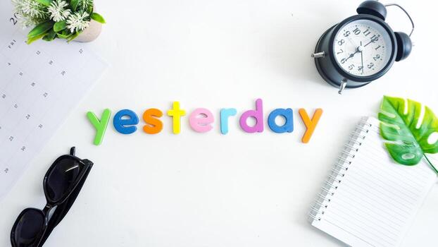 Flat lay composition with colorful foam letters spelling text YESTERDAY isolated on white background photo