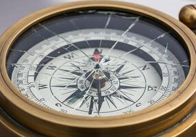 A broken compass with a broken glass photo