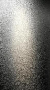 Smooth metallic surface with gradient effect, showcasing blend of silver and gray tones. subtle highlights create sense of depth and texture, evoking modern and sleek aesthetic photo