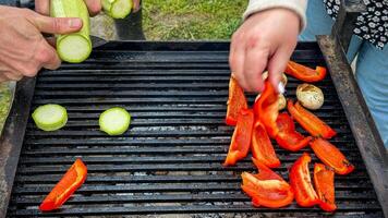 Grilled peppers and zucchini slices sizzling, rustic open air picnic, vibrant veggie fest, midsummer solstice feast, multicultural gathering photo