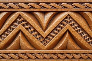Polynesian pattern carved in light brown wood creating a beautiful texture photo