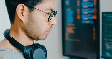 Closeup young adult Asia male freelance eyeglasses typing write prompt AI bot IT app program nomad, game, terminal with coding, user interface, designer, big data center on desktop computer. photo