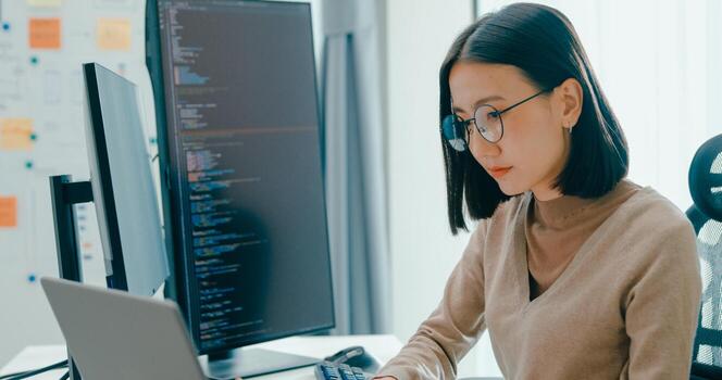 Young adult Asia female freelance write prompt AI bot IT app smart program nomad, game, terminal with coding, user interface, designer, big data center on desktop computer. photo