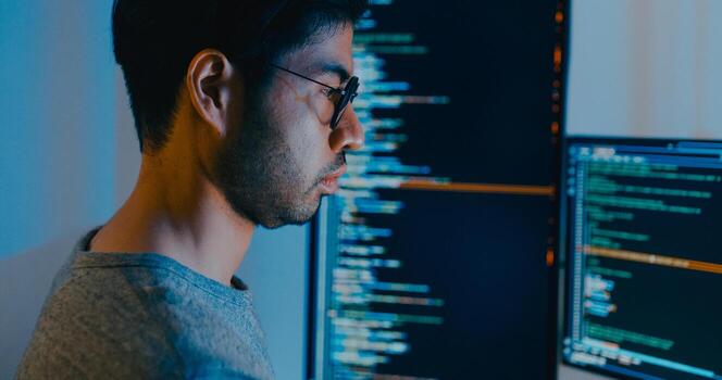 Closeup Asia male freelance typing write prompt AI bot IT app smart program nomad, game, terminal with coding language, designer, big data center on desktop computer in night office photo