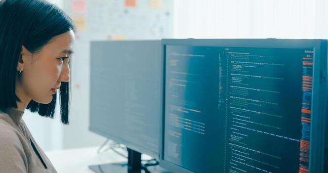 Young Asia female freelance write prompt AI IT app smart program nomad, game, terminal with coding language, user interface, designer, big data center on desktop computer. photo