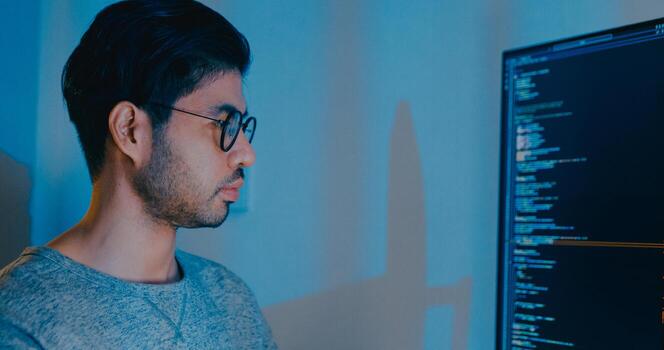 Closeup young adult Asia male freelance typing write prompt AI bot IT app smart program nomad, game, terminal with coding language, designer, big data center on desktop computer in night office. photo