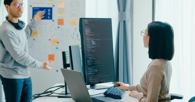 Group Asia male female software developers mentor leader manager talk strategy plan to executive write prompt AI bot IT app program nomad, data center. Whiteboard slideshow code photo