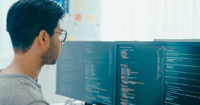 Closeup young Asia male freelance eyeglasses typing write prompt AI bot IT app program nomad, game, terminal with coding, user interface, designer, big data center on desktop computer. photo